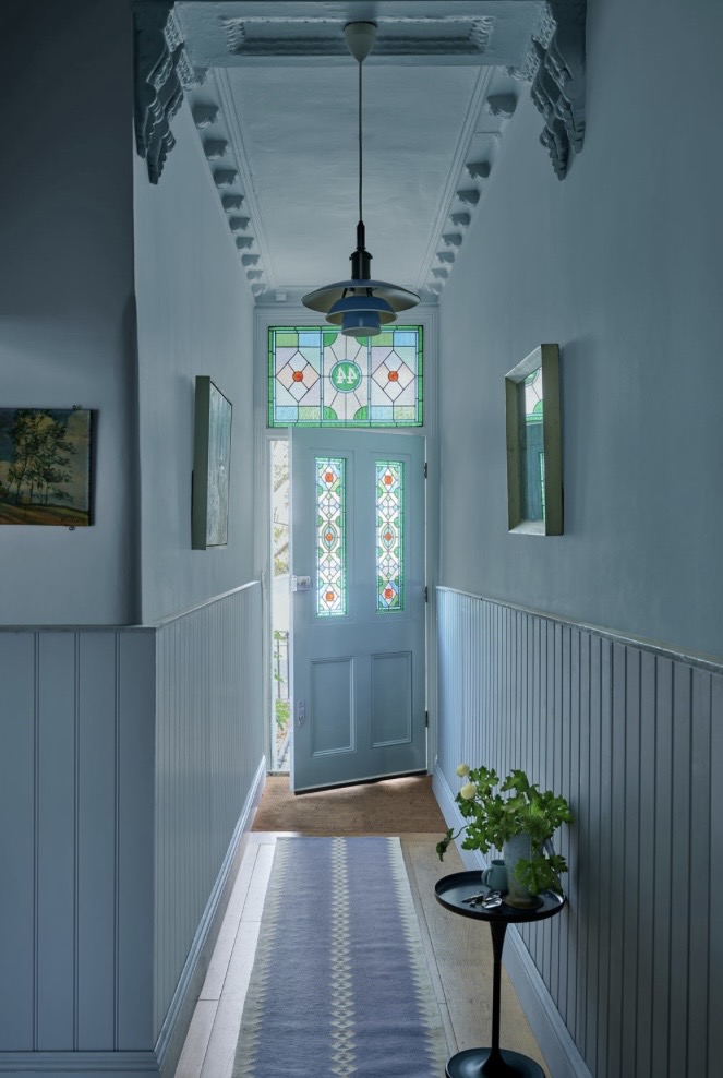 Narrow terraced hallway with Selvedge half-height panelling and stained glass door