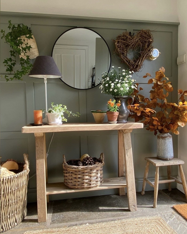 Muted green panelled console nook with autumnal seasonal styling