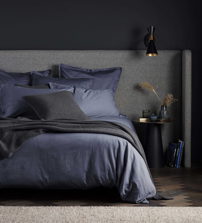 navy and grey bedroom with french blue bed linen