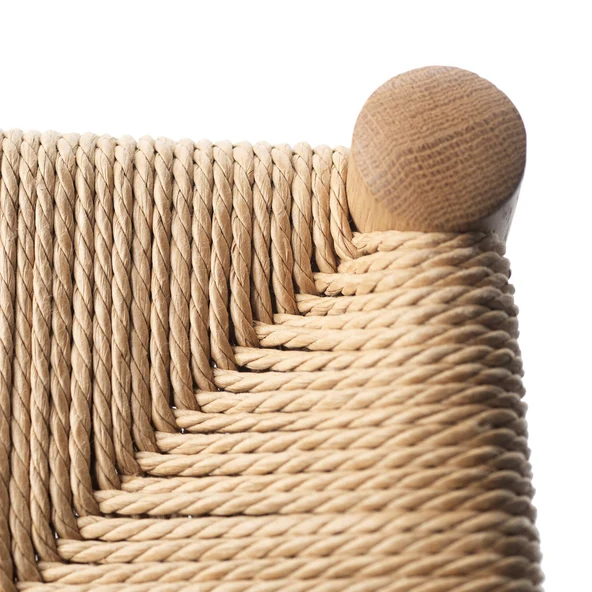 Close-up of a woven paper cord seat wrapped around a turned oak corner post