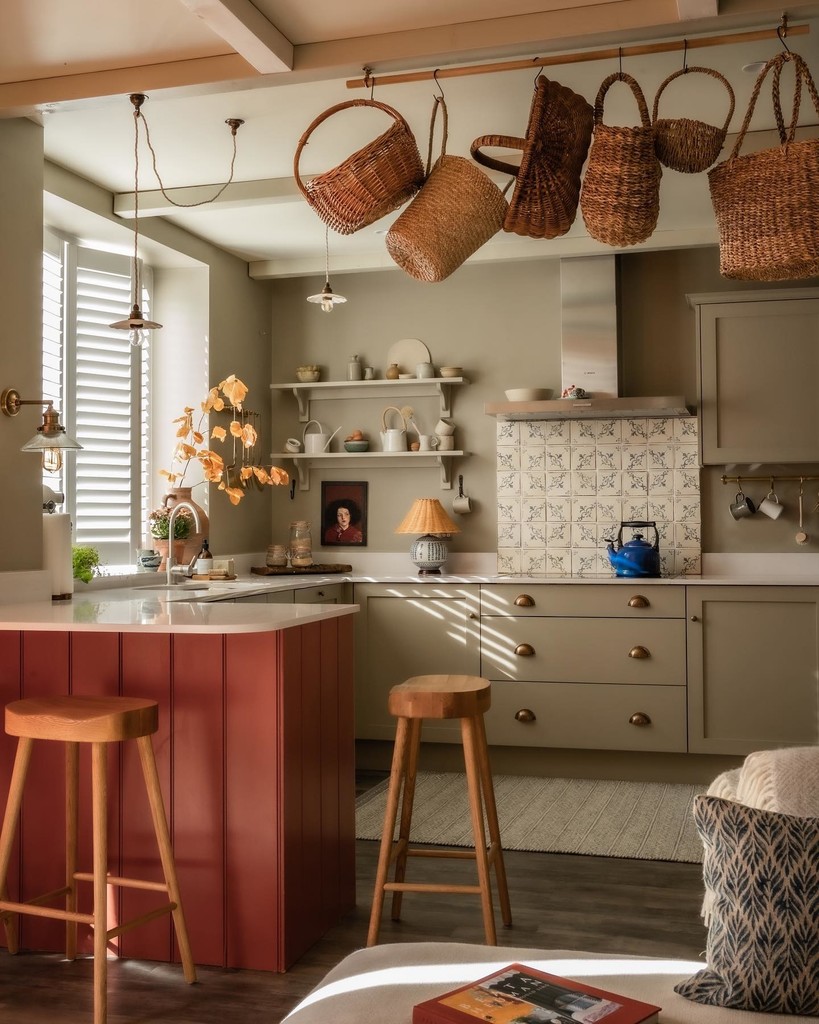 Two backless timber breakfast bar stools at a terracotta panelled peninsula in a Light Gray kitchen