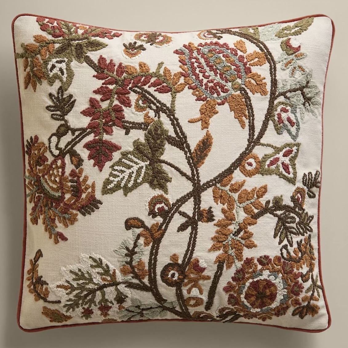 Ecru cotton cushion embroidered with burnt orange, rust and olive florals