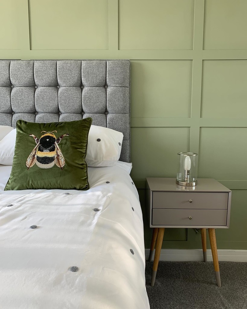 green and grey bedroom with tufted headboard