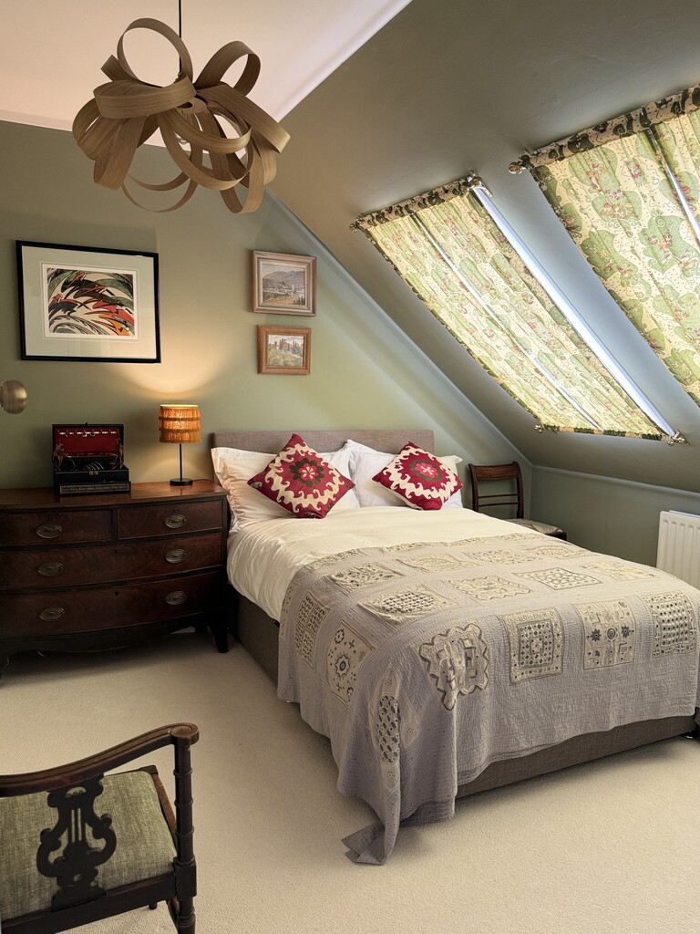 green and grey bedroom with vintage quilted bedspread