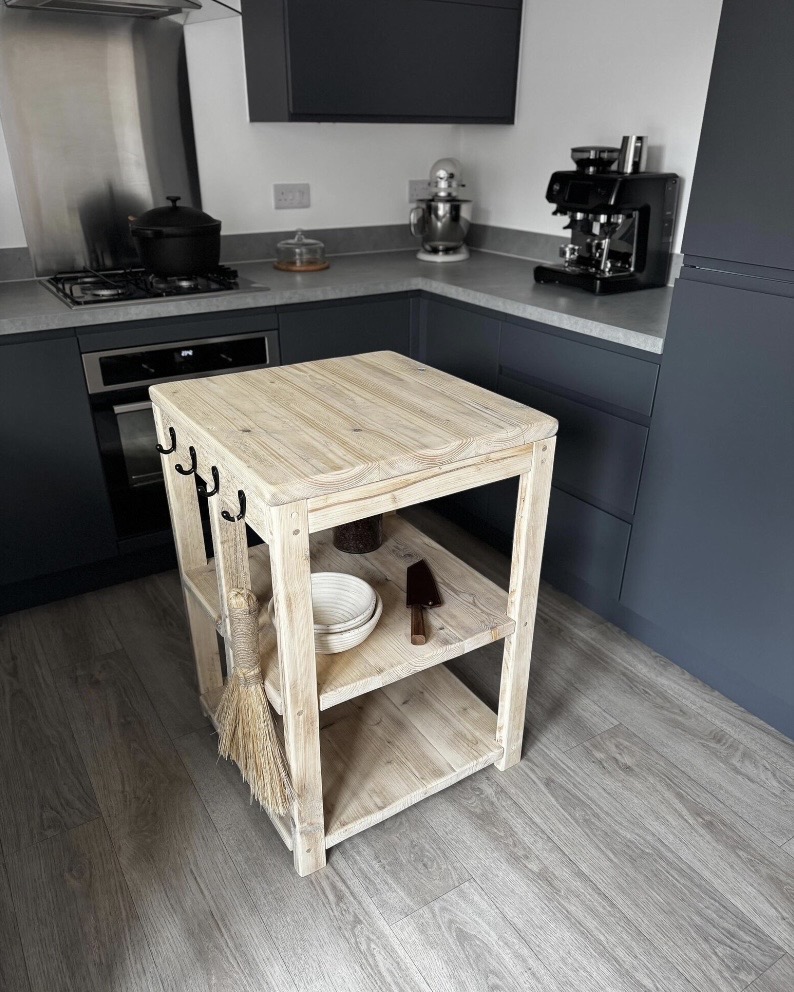 Handmade reclaimed wood butcher's block kitchen island with shelves and iron hooks