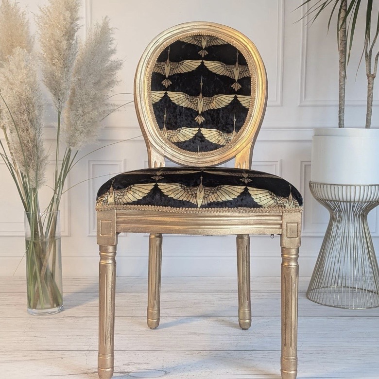 Gilded Louis-style accent chair upholstered in black crushed velvet with a gold Art Deco crane print