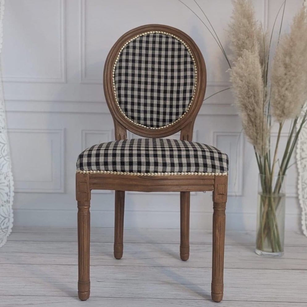 Black and cream gingham Louis-style accent chair with an oval medallion back, brass stud trim and a carved oak frame