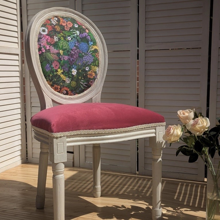 Louis-style medallion accent chair with a multicoloured floral print on a dark ground and a raspberry velvet seat