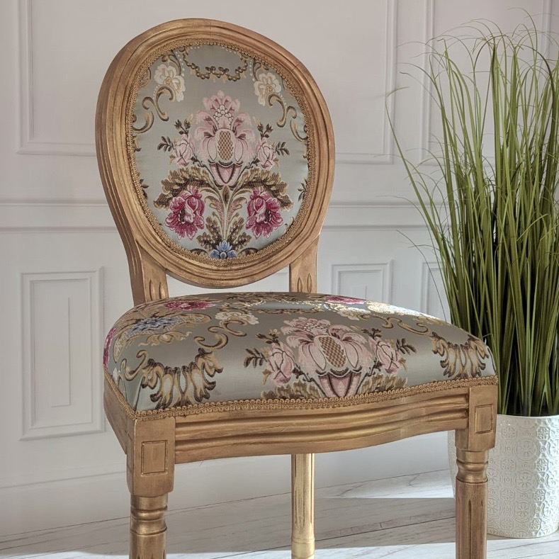 Gilded Louis XVI-style accent chair upholstered in a rose and sage floral brocade with an oval medallion back