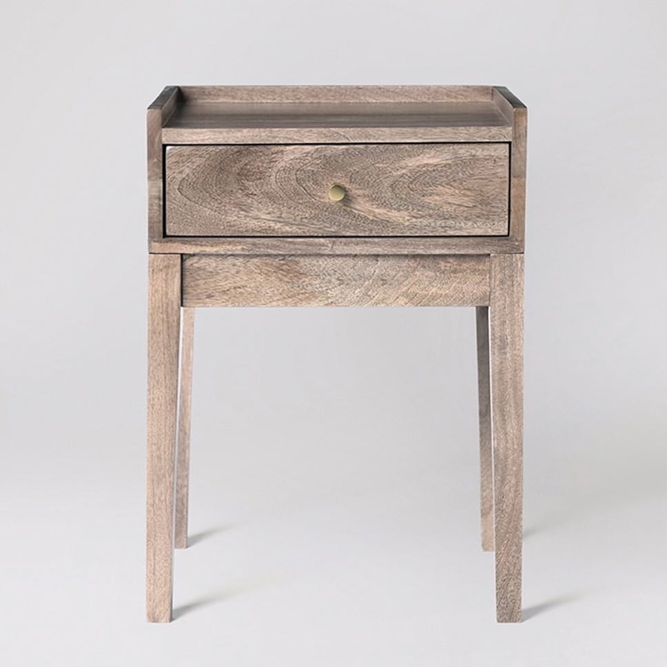 Newham mango wood bedside table with a single drawer and brass handle for a pink and green bedroom