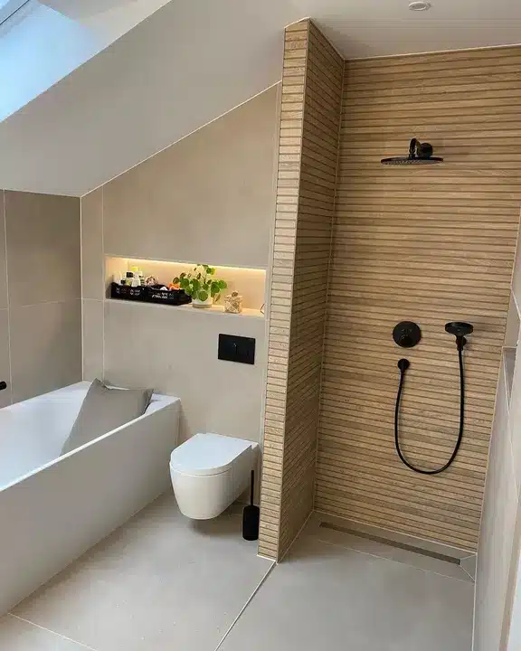 Horizontal slatted wood-effect tiles in a loft walk-in shower with matt black fittings