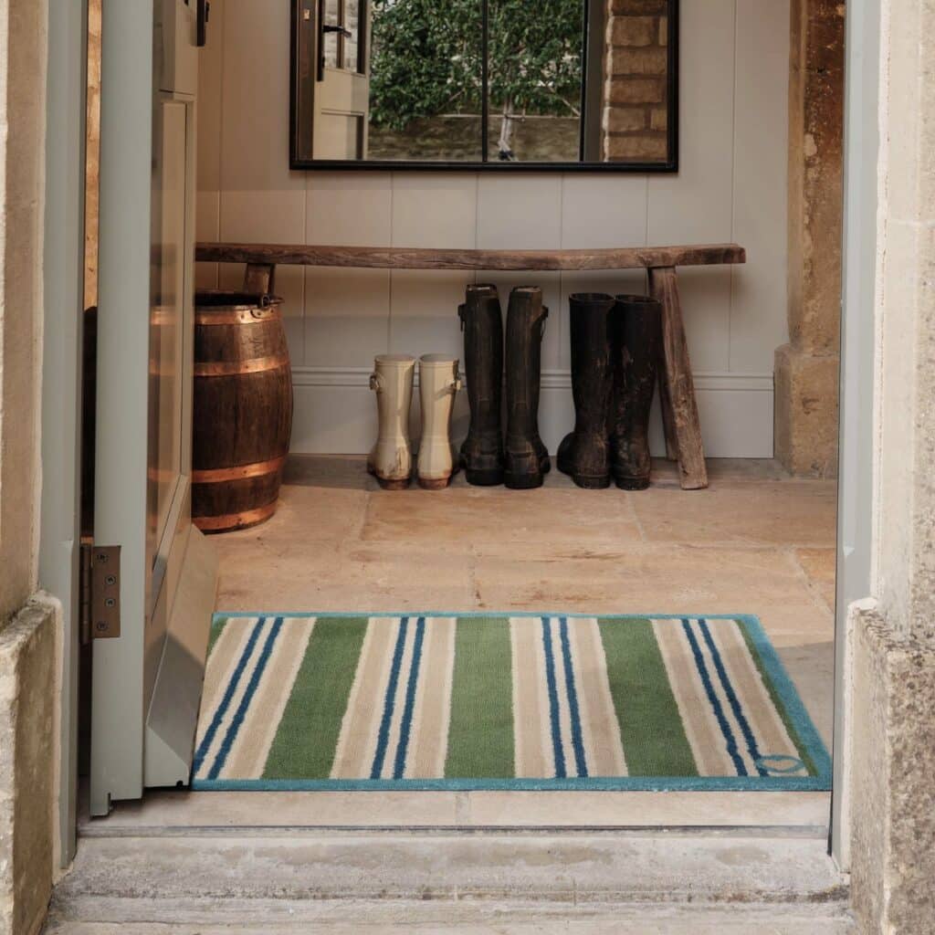 green stripe washable doormat in boot room with wellington boots