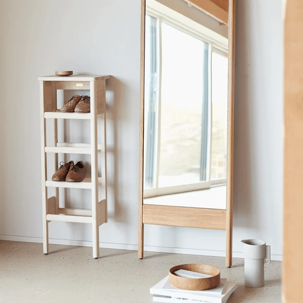 Form and Refine oak ladder shoe rack beside floor mirror