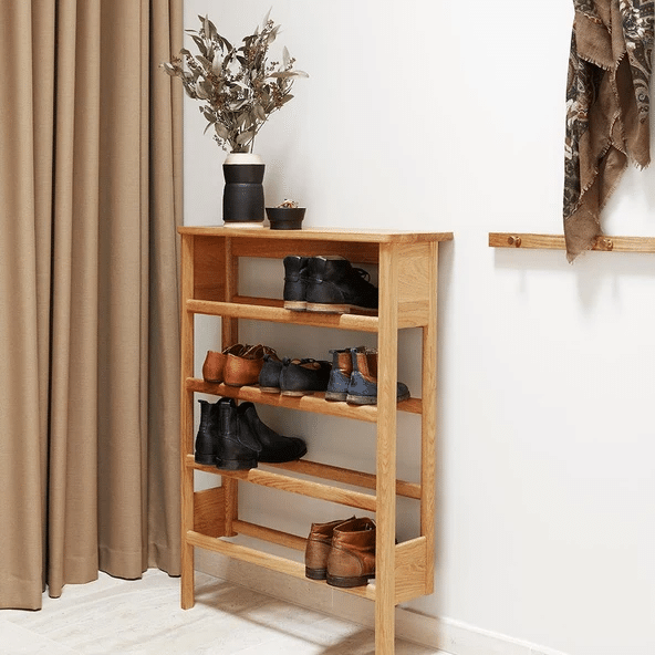 tall oak ladder shoe rack with boots and shoes on open shelves