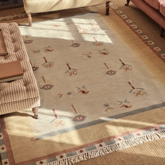 Tula kilim rug with folk floral motifs and a soft yellow border