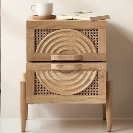 Mango wood bedside table with cane spiral carved drawers in a boho beige bedroom