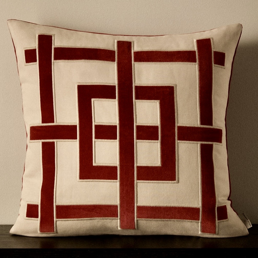 Burgundy velvet geometric appliqué cushion on cream cotton