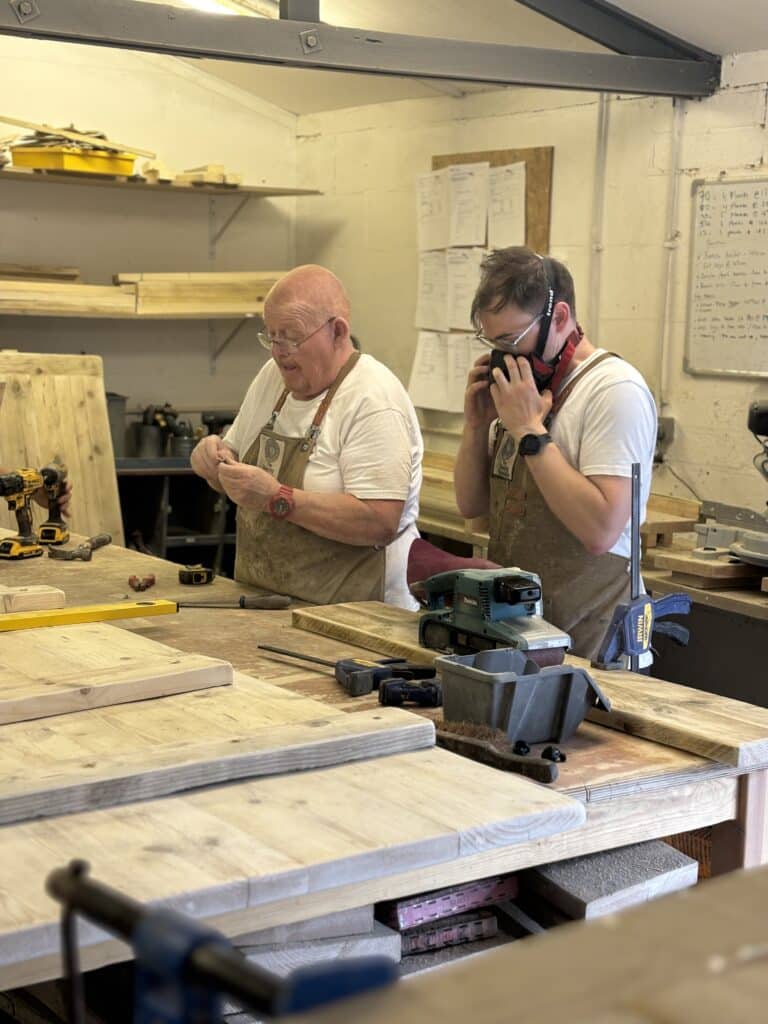Aaron of The Dancing Woodman, British furniture maker, in his reclaimed wood workshop near Southampton