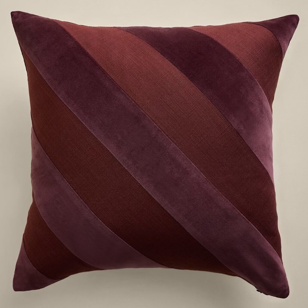 Burgundy velvet cushion with tonal plum and wine diagonal stripes
