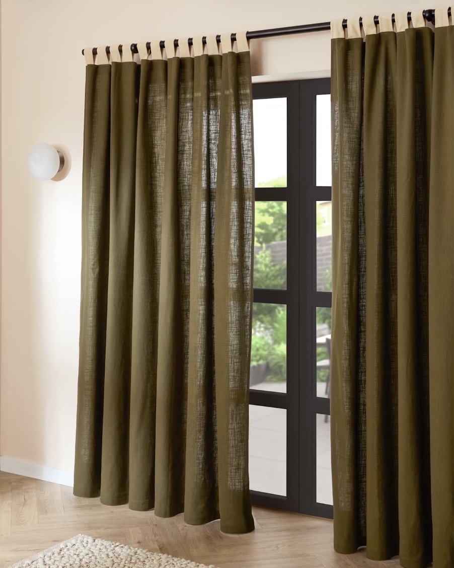 Green cotton curtains with buttermilk velvet tab loops on a black pole