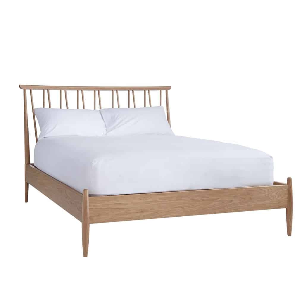 Ercol Winslow oak spindle bed for a modern beige bedroom