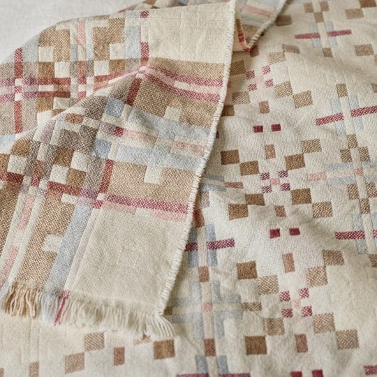 Elsie woollen blanket with a geometric pattern in pink, brown and soft blue